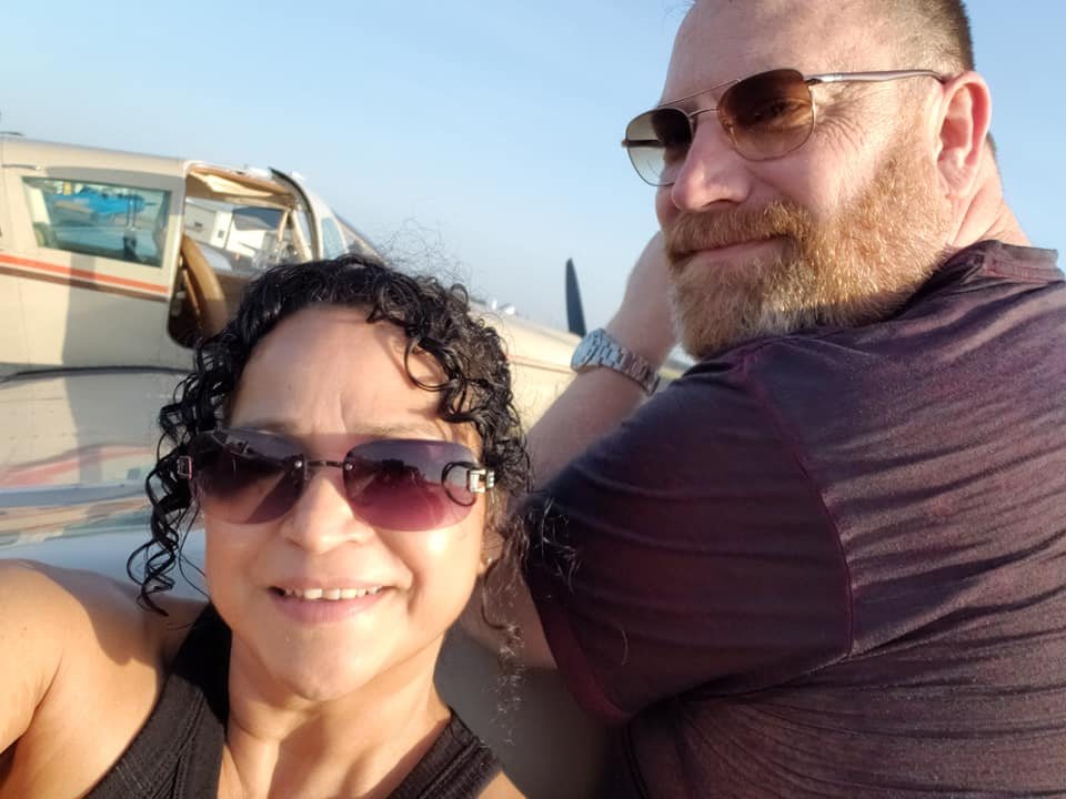 Anthony and Alicia next to their airplane